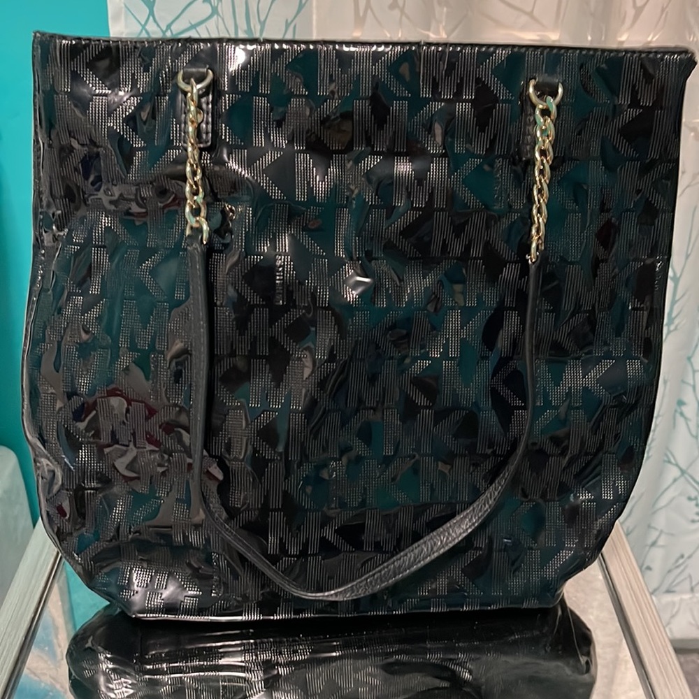 Black bag. Michael Kors patent signature prints bag with gold hardware.